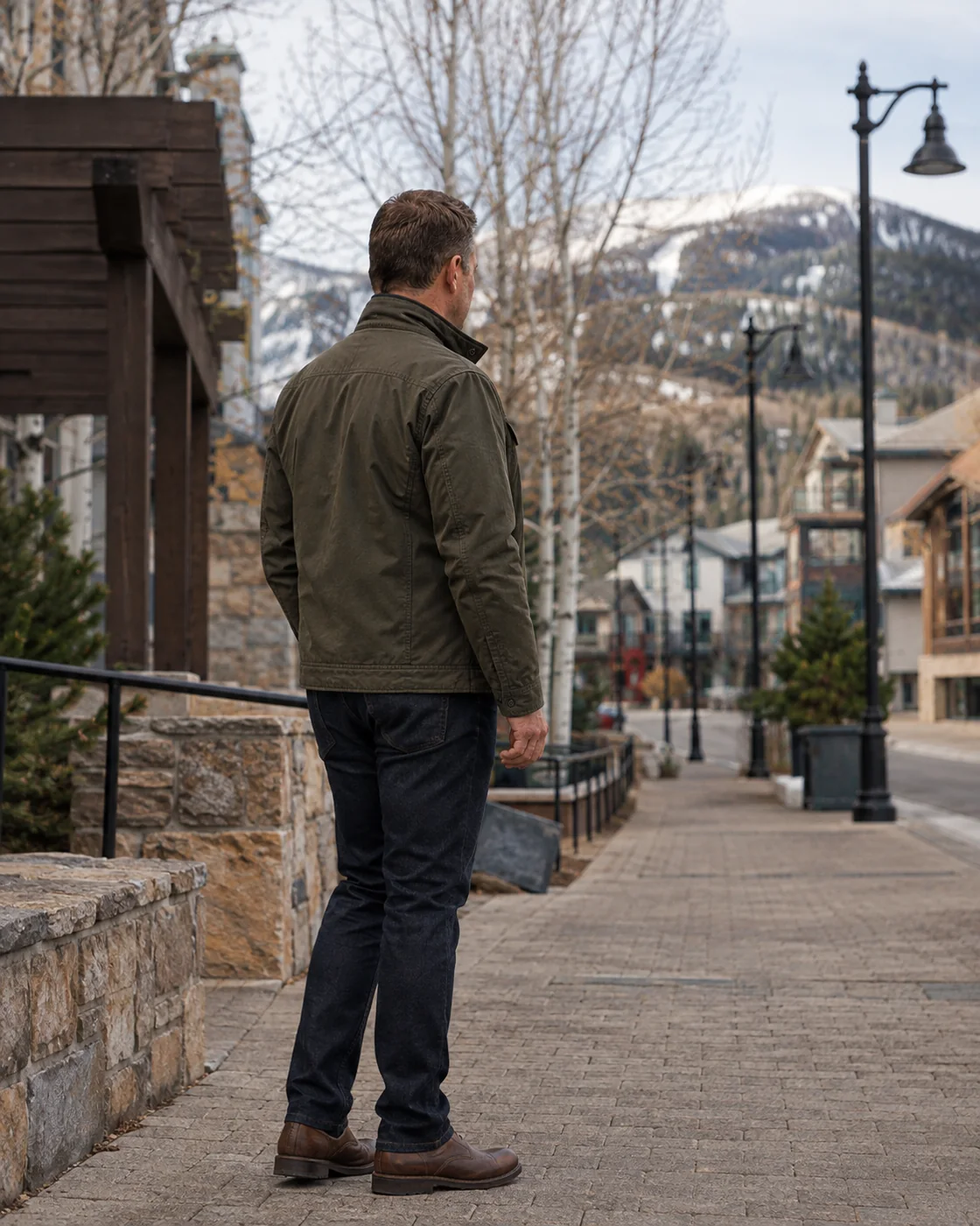 The Wasatch Mountain Concierge principal overlooking a quiet mountain village walkway.